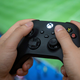 A man holds a controller of the Xbox Series X gaming console.